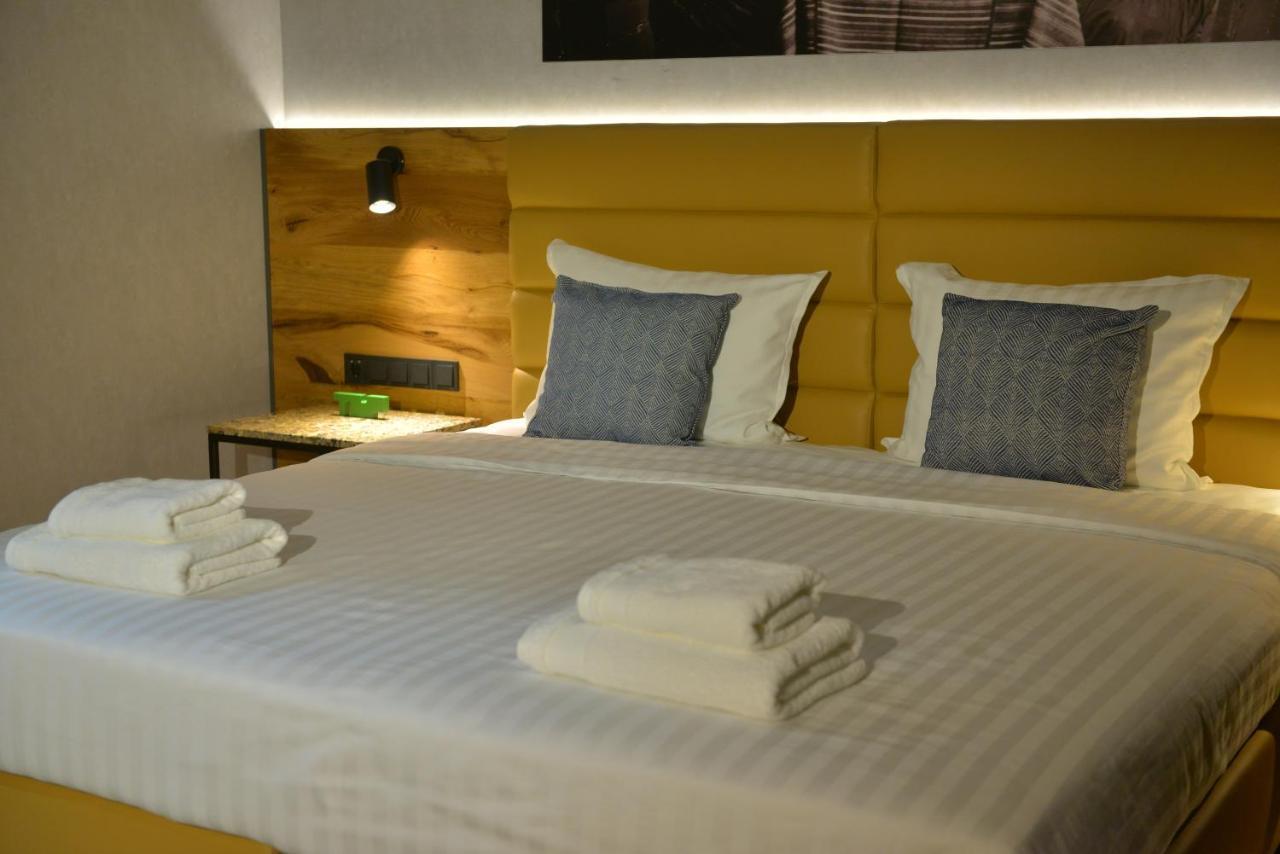 Mk Hotel Tirana Rinas 외부 사진 A bed with a headboard